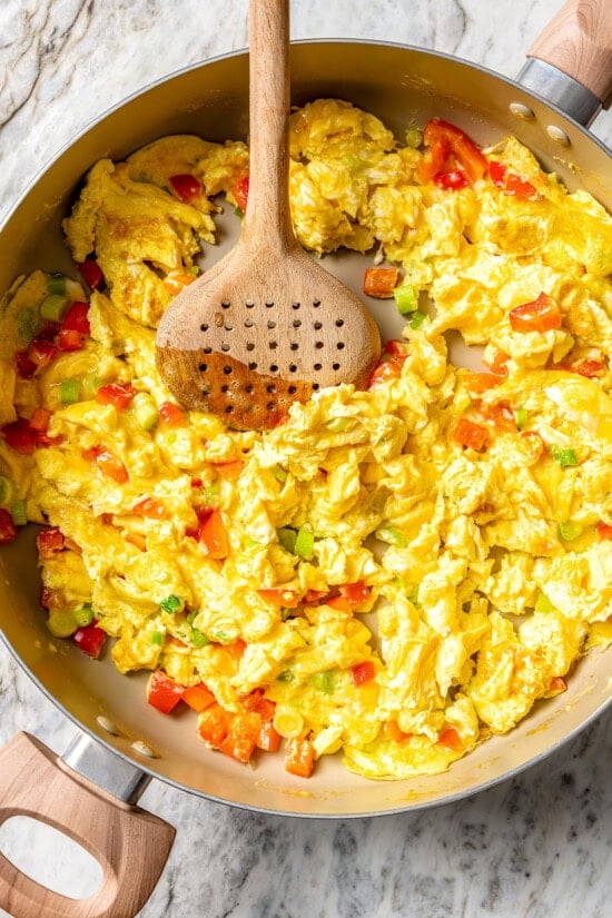 Scrambled eggs and veggies in pan