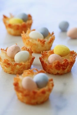 Easy gluten free coconut macaroons shaped like a bird's nest, filled with mini chocolate Cadbury eggs – a tasty Easter treat!