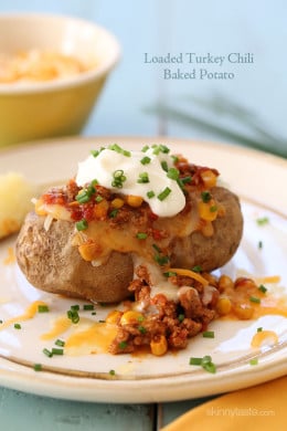 This loaded baked potato is stuffed with lean turkey chili, reduced fat shredded cheese and topped with some fresh chives – a quick, easy weeknight meal.