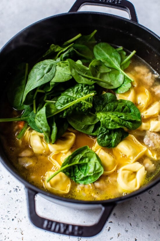 Add the broth, sausage and tortellini to the soup