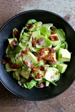 This shredded raw brussels sprout salad with bacon and avocado can be eaten as a main or a side dish. Because raw brussels stand up so well to dressing, it's also great to make ahead – just add the avocado right before serving.